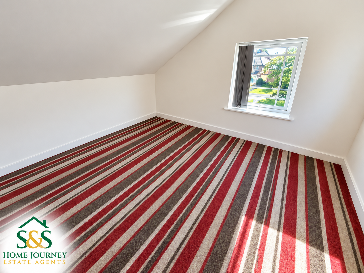 Unfurnished room with striped carpet at the Tyseley home
